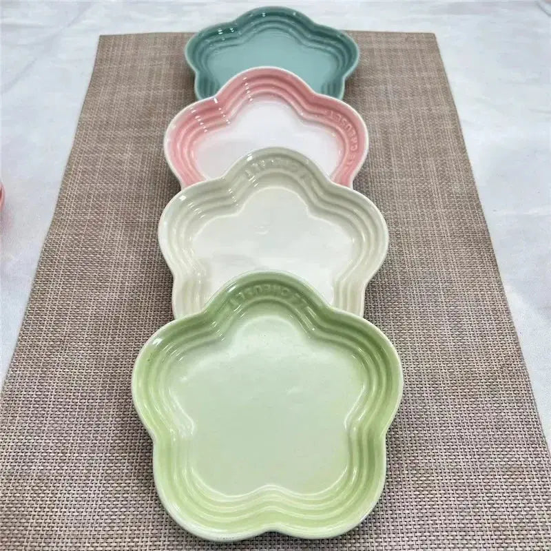 Pastel flower-shaped ceramic pet bowls in green, pink, and white for dogs or cats